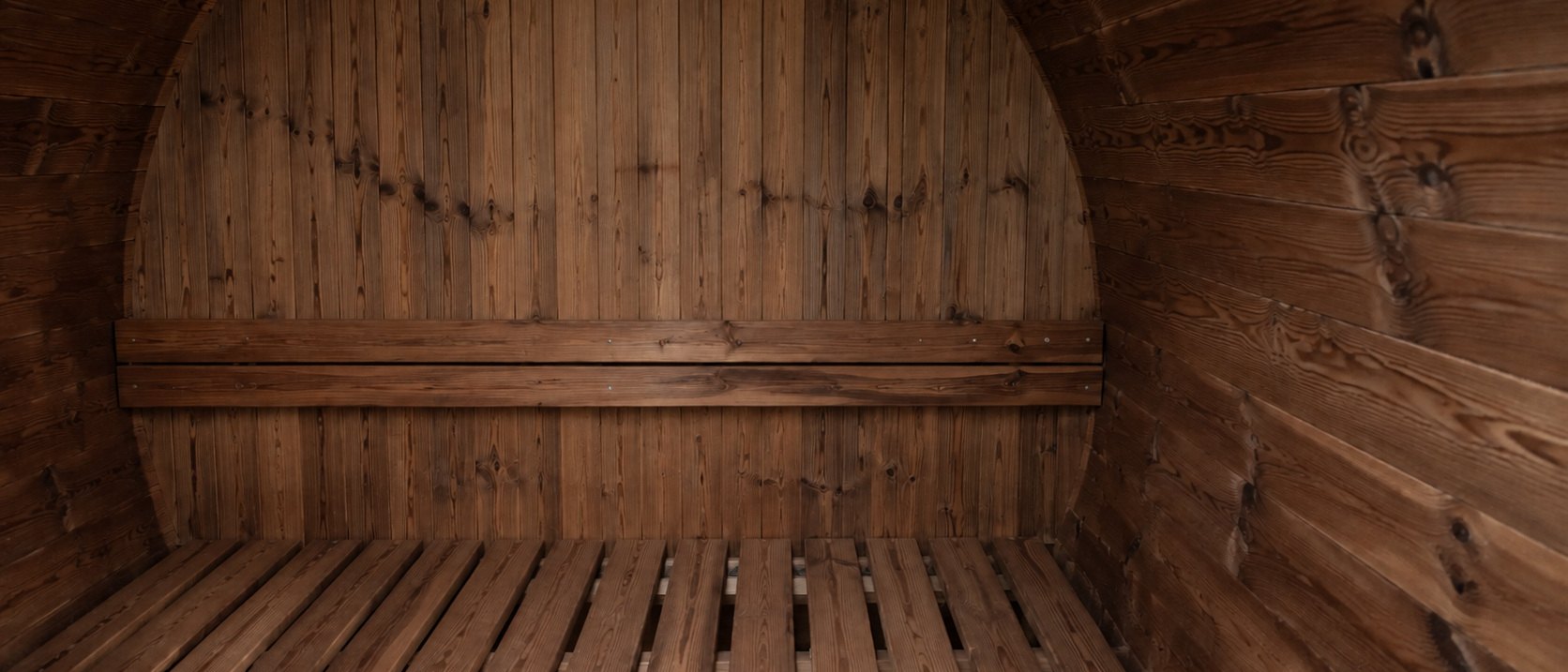 The interior of a BANYA sauna, bench and curved timber