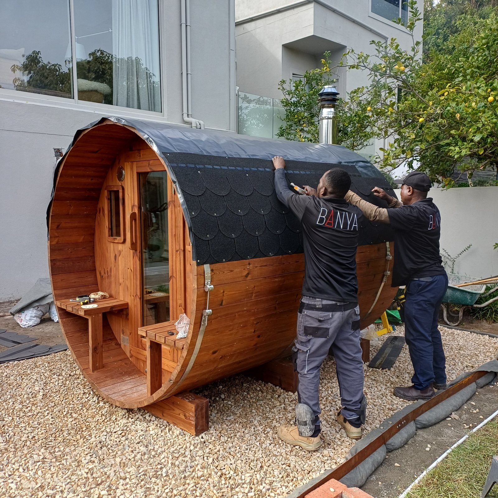 The BANYA team fitting the shingle roof on site