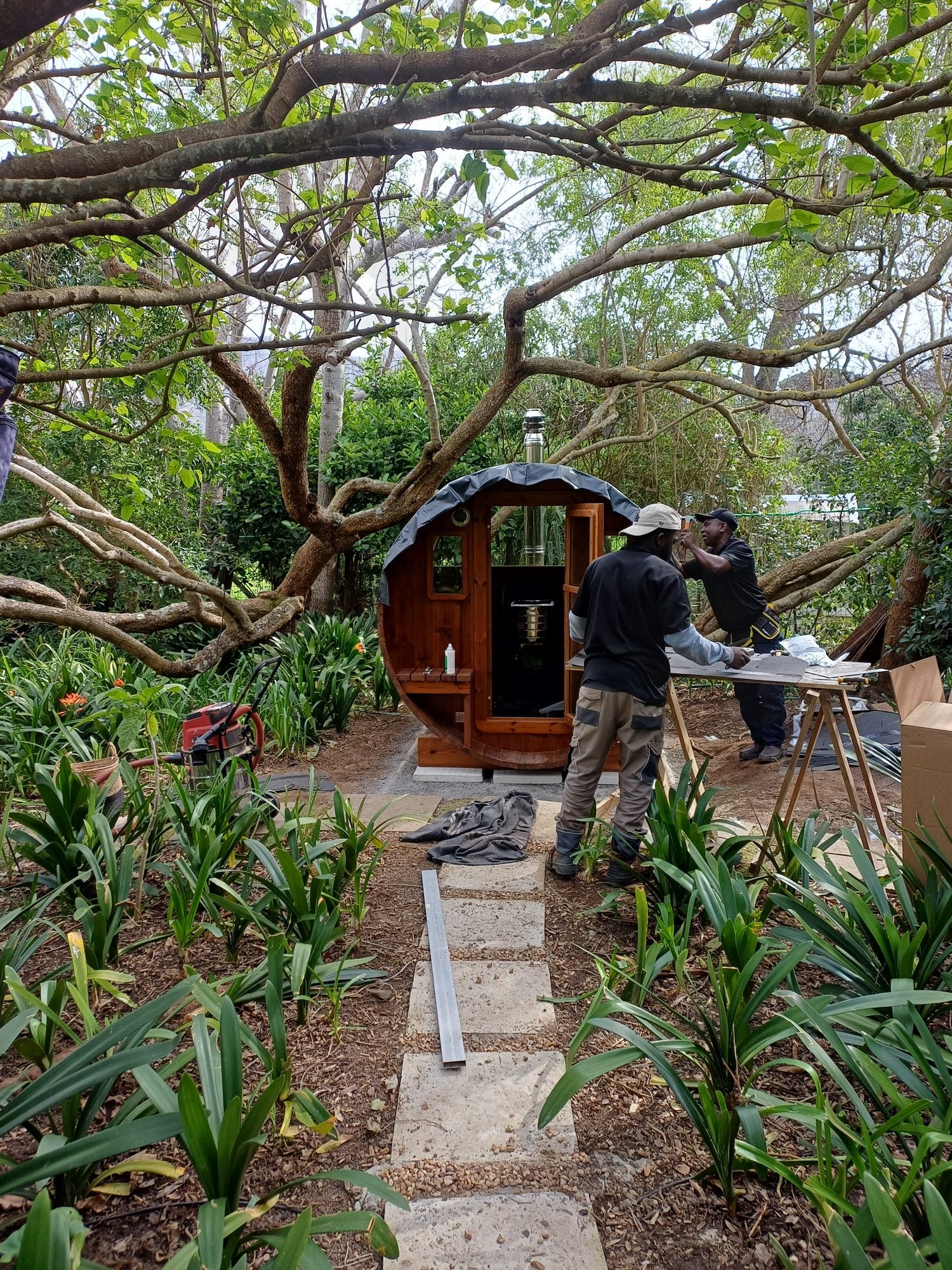 Carrying the staves down through the garden